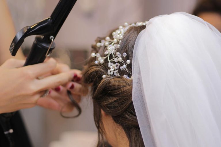 Stylist consulting with bridal client in busy salon during spring event season