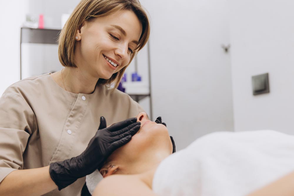 Professional esthetician providing safe beauty treatment consultation in a salon setting